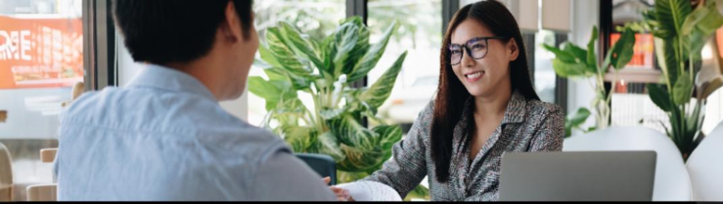 Smiling candidate talking with a recruiter during an interview in a bright office